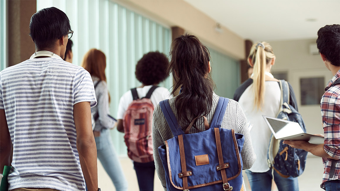 Students walking down a hallway. 